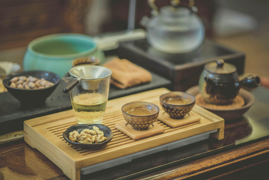 Traditional Korean tea set with herbal tea and snacks on a wooden tray—evoking natural wellness practices aligned with Aldicom’s herbal hangover relief formula